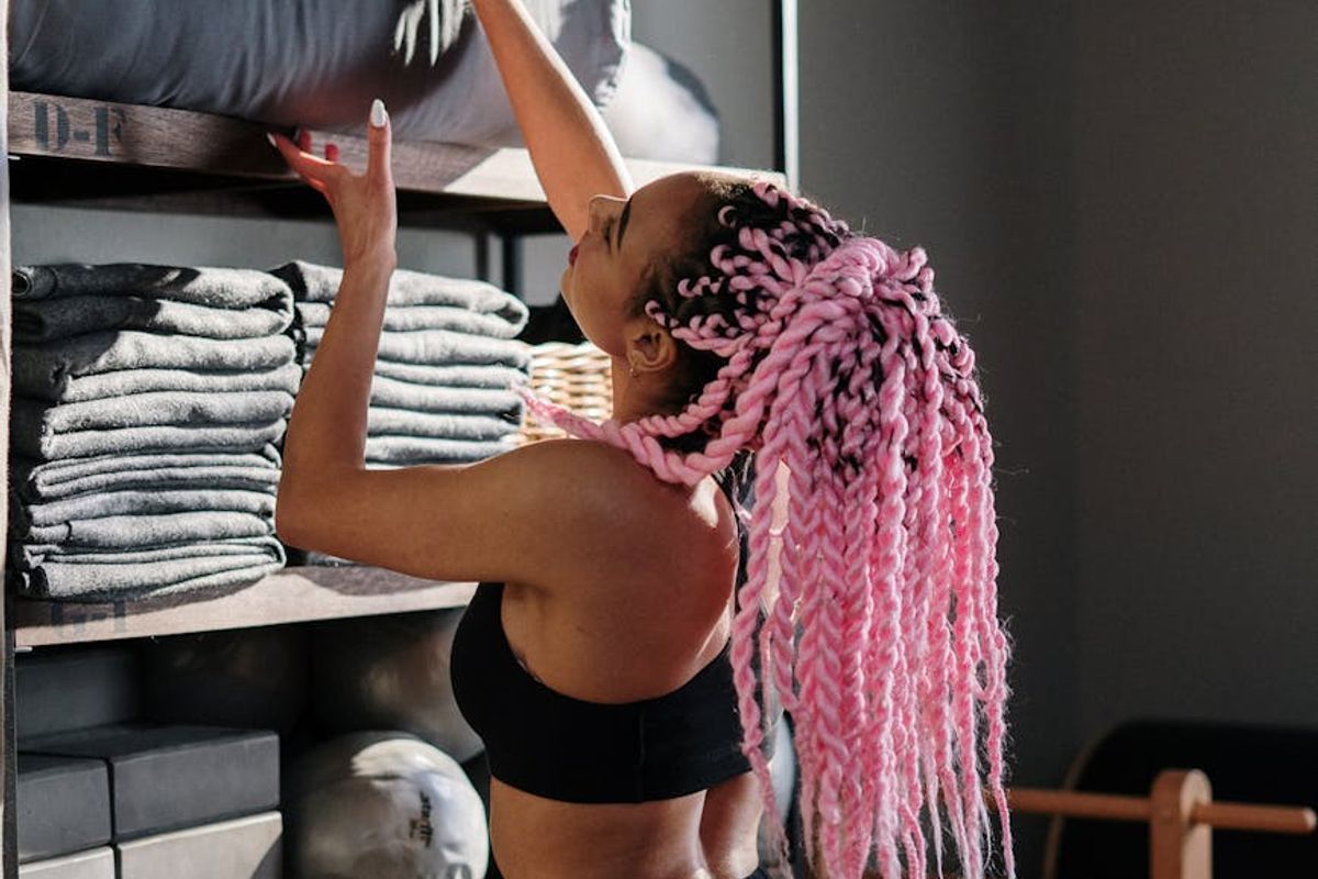 Professional yoga instructor performing a balance pose in a minimalist studio.